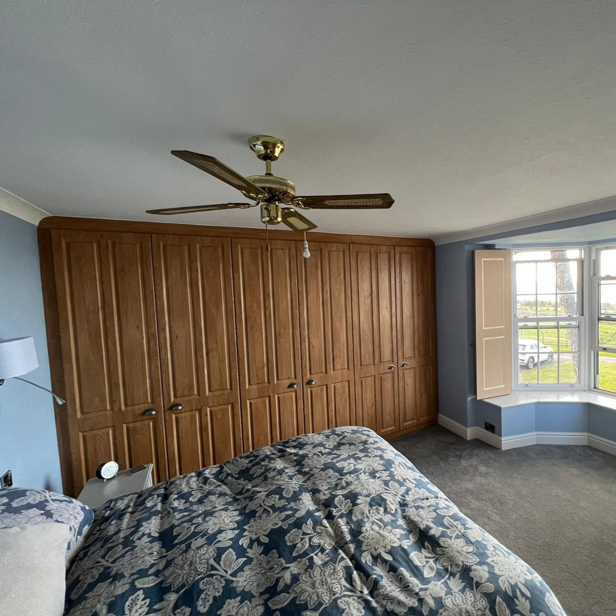 Custom fitted wooden wardrobe in bedroom